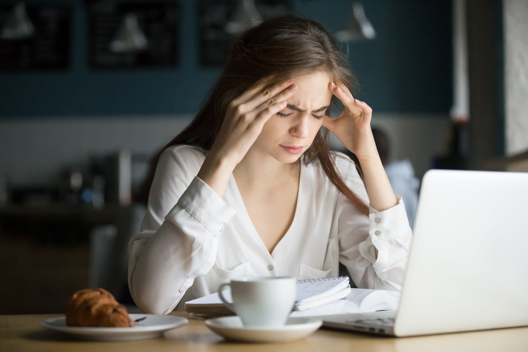 woman working with a migraine