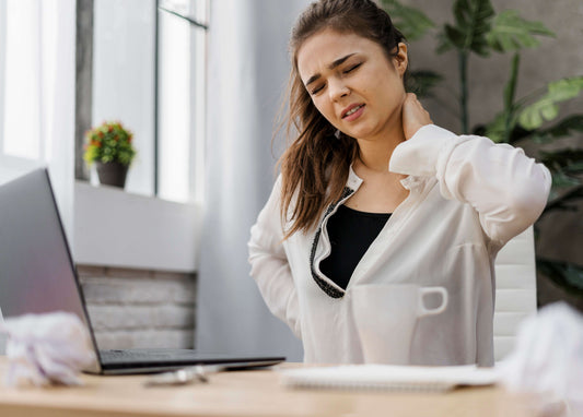 woman with neck ache in office