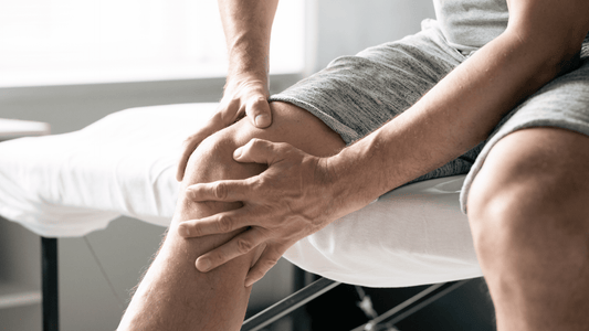 A man holding his knee in response to the join pain